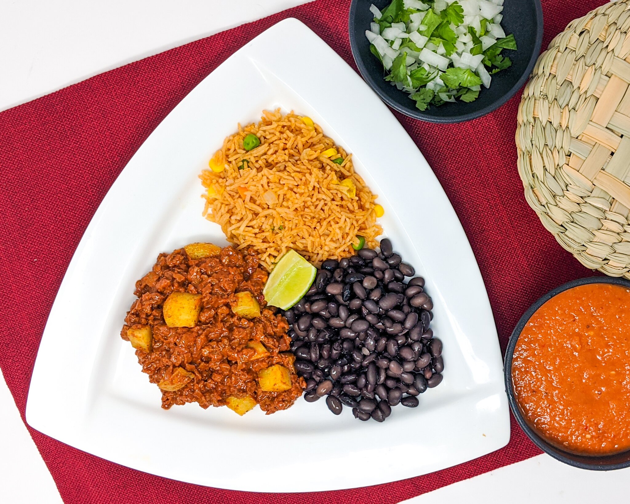 Vegan taco plate with soyrizo, potatoes, rice, beans, and salsa for catering}